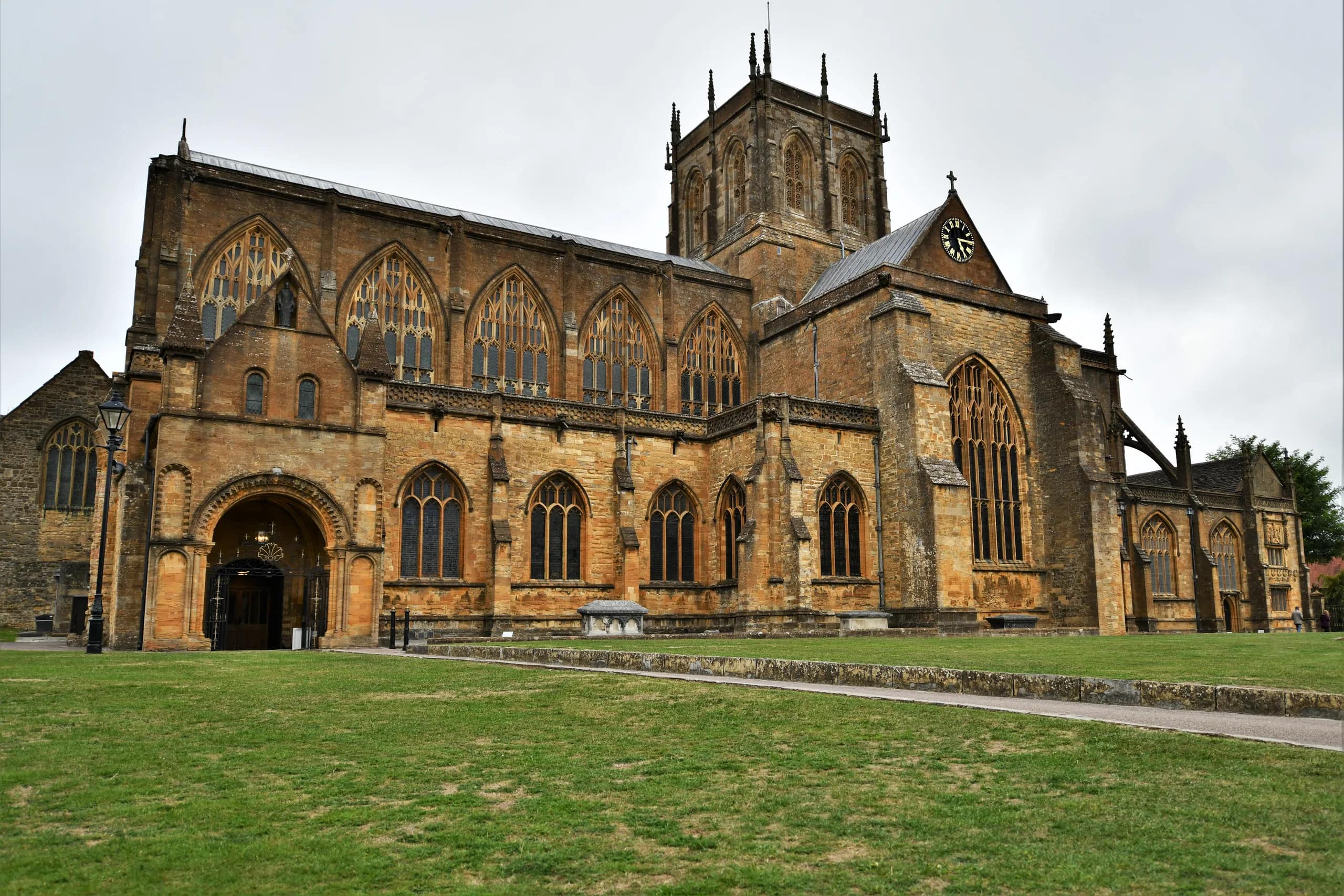 Sherborne Abbey seen across the lawn on a summer day