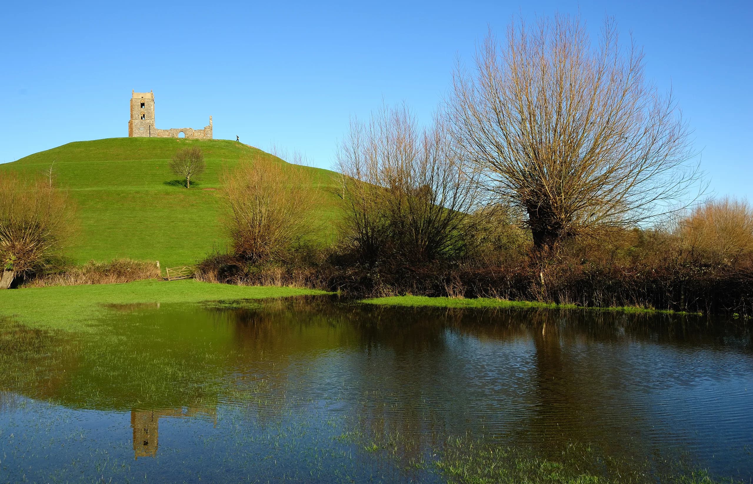 Burrow Mump and St Michael's church reflected in floodwater on the Somerset Levels near Langport