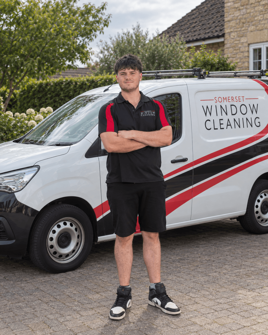 Leon, Window Cleaner at Somerset Window Cleaning; portrait with an edited van background